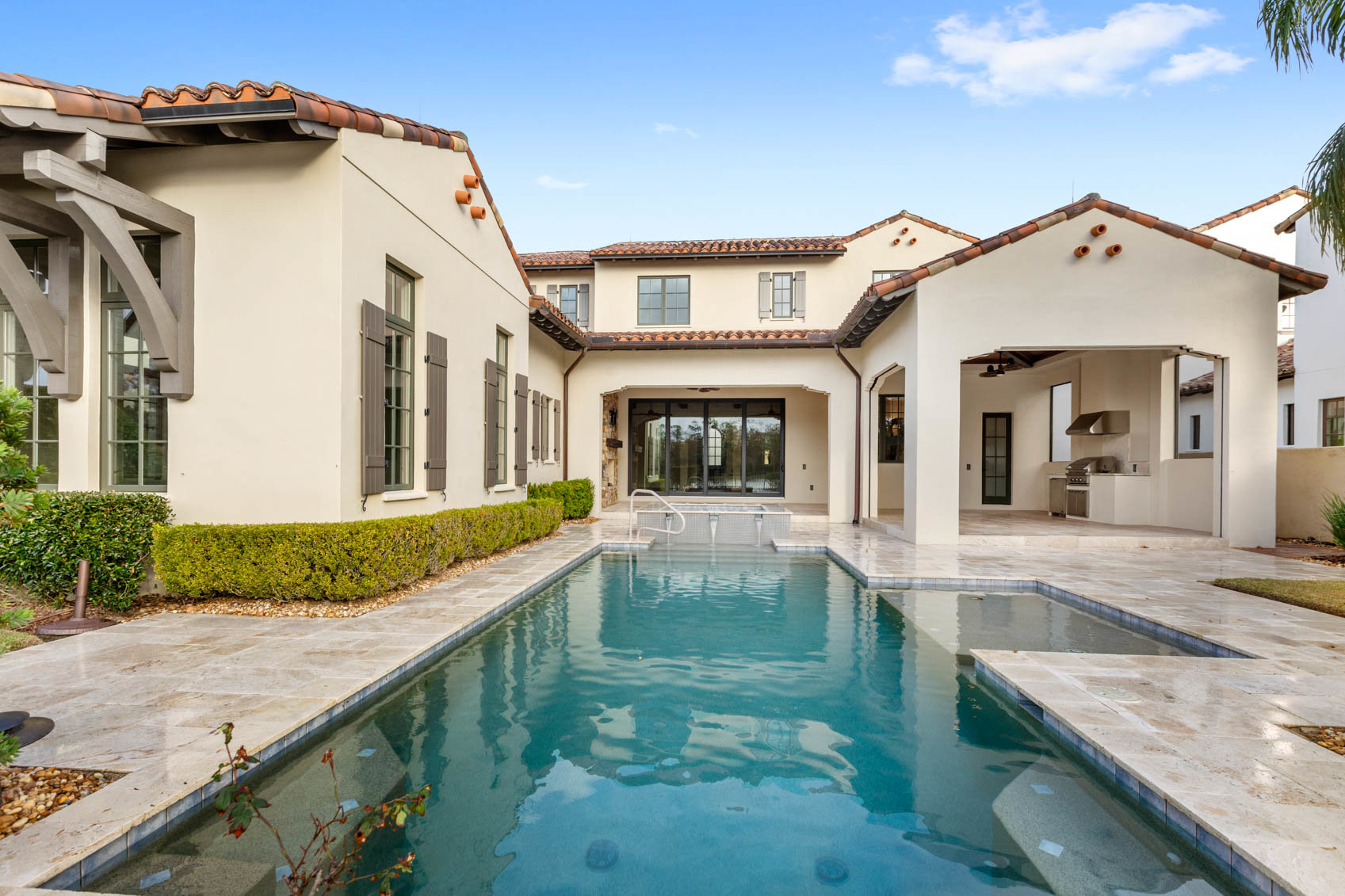 back of home with large pool